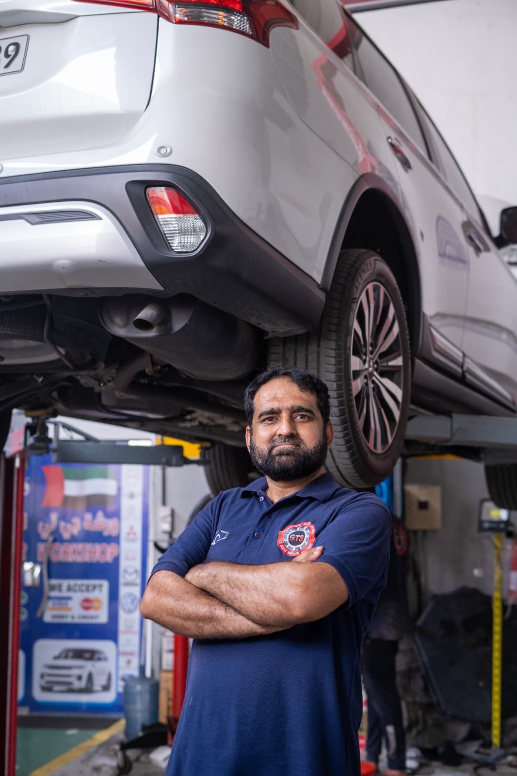 GTS technician standing below a raised vehicle in the workshop