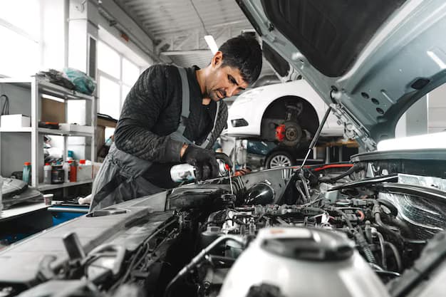 Mechanic examining an engine bay during repair service